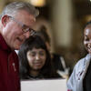 David Boardman laughing with two students in Mitten Hall