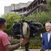 David Boardman speaking to a camera during an interview in front of the bell tower on main campus